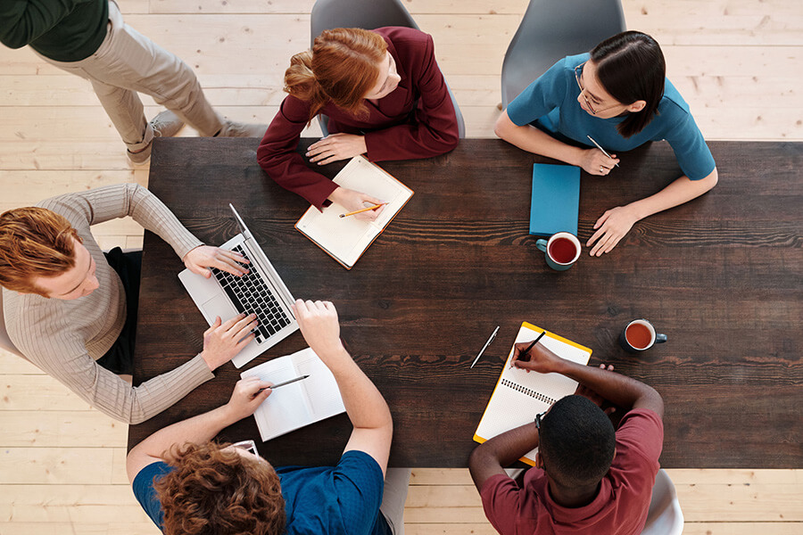 Overhead view of people working at a table and collaborating