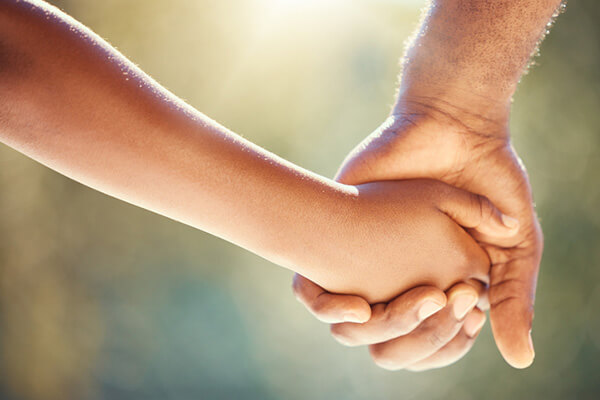 Father and child holding hands