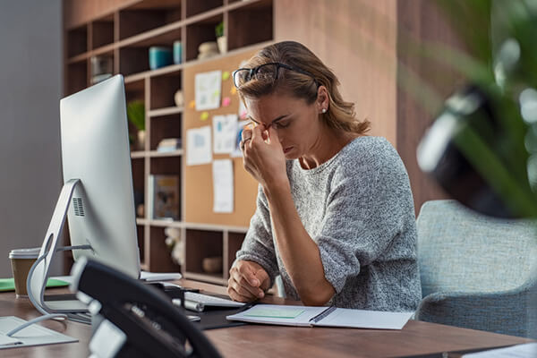Business woman having headache at office